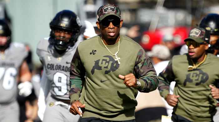 Colorado Buffaloes head coach Deion Sanders runs on to the field before a game against Arizona.